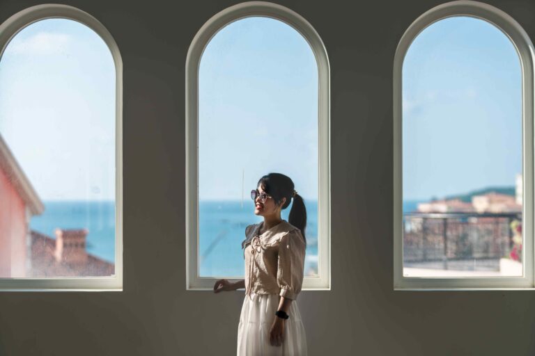 Arched windows with a woman in front of them