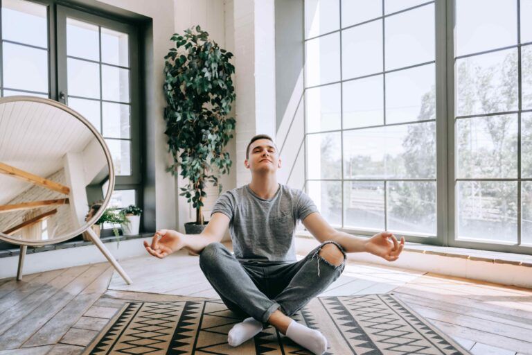 Man sitting in lotus position, meditating