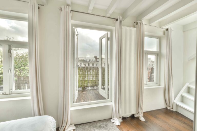 Open casement windows in a white room