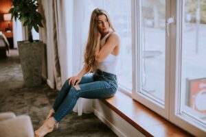 Woman sitting in front of casement windows